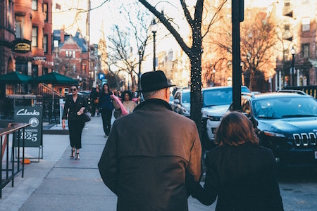 man-woman-walking-street-building-property-denver