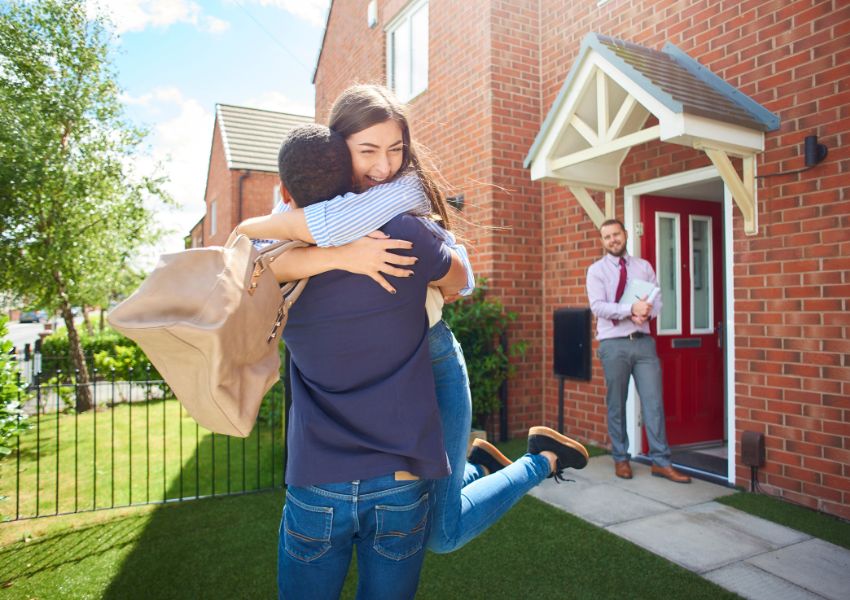 two-people-hugging-outside-home-with-landlord