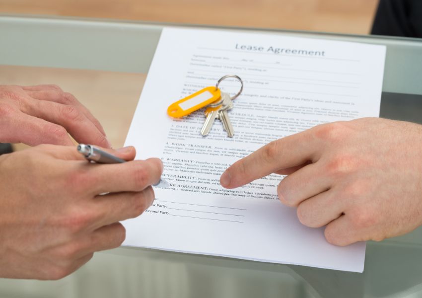 two-people-signing-lease-agreement