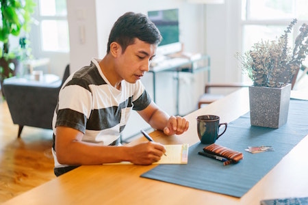 man-table-notepad-pen