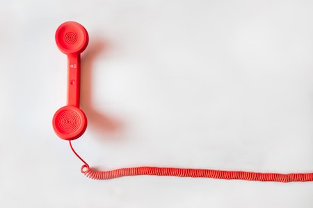 red-wired-telephone-white-background
